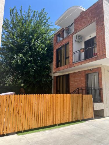 a wooden fence in front of a house at Villa for families and friends 4 in Tbilisi City