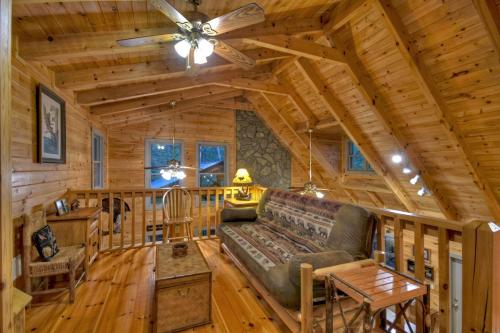 a living room with a couch in a log cabin at K6 Lodge Gather around the firepit soak in the hot tub and splash in the creek in Blue Ridge
