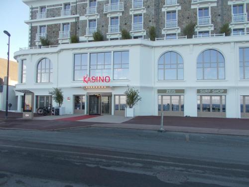 a white building with a krispy kreme sign on it at Les hortensias in Louannec