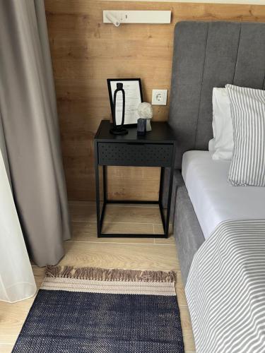 a nightstand next to a bed in a room at Apartments Mrdak in Bar