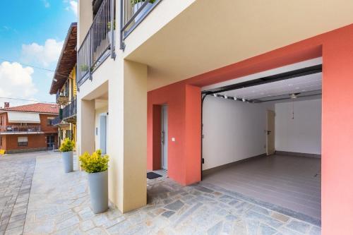 an empty courtyard of a building with an open garage at La Casa Nelle Aie - Appartamento Nebbiolo - Free WiFi e AC in La Morra