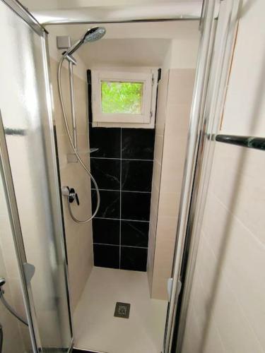a small bathroom with a shower and a window at chicca in nature near florence in Pratolino