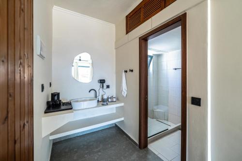 a bathroom with a sink and a shower at Elion Seaside Resort in Eretria