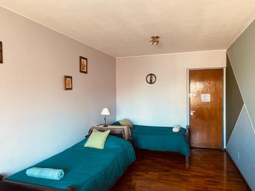 a bedroom with a blue bed in a room at TU CASA EN ESPAÑA Y PEATONAL - COCHERA PRIVADA INCLUIDA - Microcentro in Mendoza