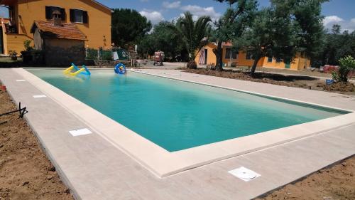 a swimming pool with two slides in the water at Agriturismo da Remo in Magliano in Toscana