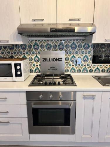 a kitchen with a stove with a box on it at La casina di Ale in Turin