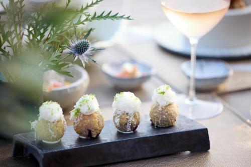 a group of food items on a table with a glass of wine at Porto Sani in Sani Beach