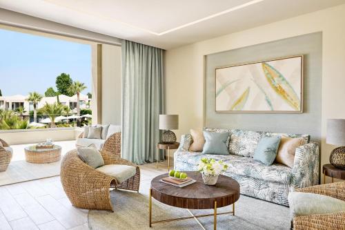 a living room with a couch and a table at Porto Sani in Sani Beach