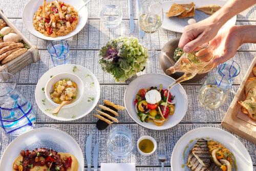 a table with plates of food on it at Ikos Olivia in Gerakini