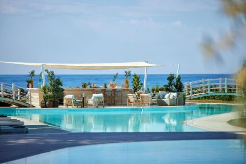 a swimming pool with a view of the ocean at Ikos Andalusia in Estepona