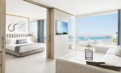 a bedroom with a bed and a living room at Ikos Andalusia in Estepona