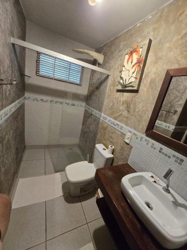 a bathroom with a toilet and a sink at Stay Cool Pipa in Pipa