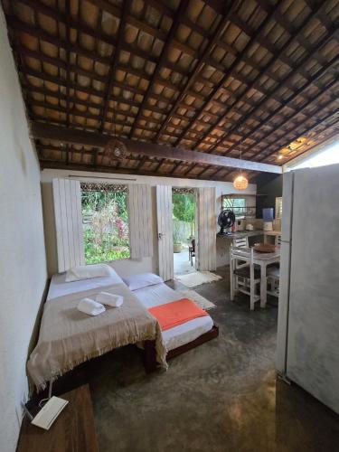 a bedroom with a bed and a desk in it at Stay Cool Pipa in Pipa