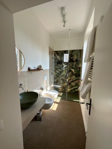 a bathroom with a sink and a glass shower at Villa del Parco in Poggi