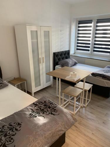 a living room with a table and a bed at Unterkunft Mara in Oberhausen