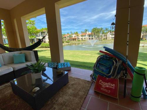 a living room with a hammock and a couch with a surfboard at Villa De Palma -Oceanfront community w generator in Sabana