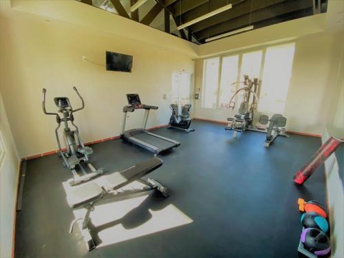a gym with several tread machines in a room at Villa De Palma -Oceanfront community w generator in Sabana