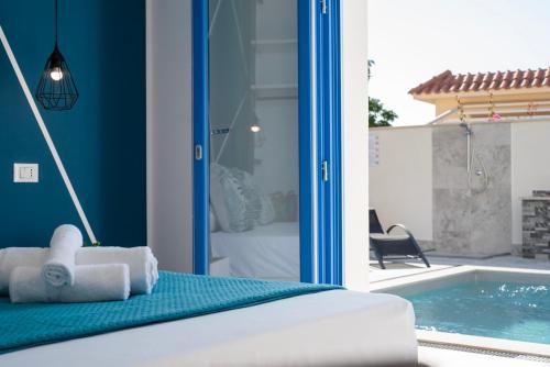 a bedroom with a bed and a swimming pool at Bed and Breakfast Da Francesca in Castelluzzo