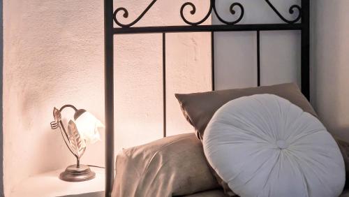 a bed with a pillow and a lamp next to it at Il Castello degli Ulivi-Agriturismo in natura in Roccella Ionica