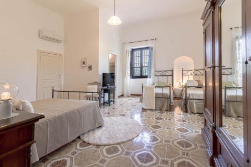 a bedroom with a bed and a living room at Il Castello degli Ulivi-Agriturismo in natura in Roccella Ionica