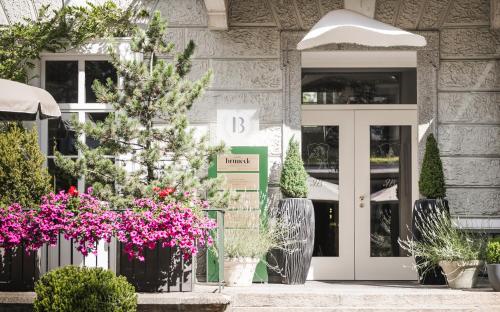 a building with flowers in front of it at Hotel Bruneck Design-Suites in Brunico