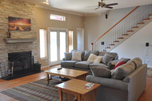 a living room with a couch and a fireplace at Balcony Suite 2 Fraser Family Vineyard Stay in Amador in Plymouth