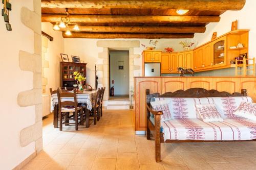 a kitchen and dining room with a table and chairs at Villa Aloni in Fílippos