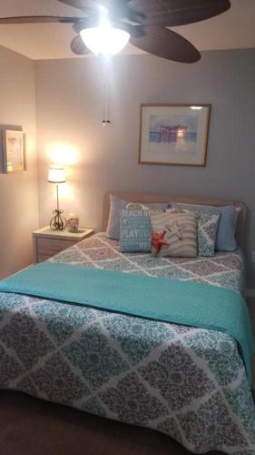 a bedroom with a bed and a ceiling fan at Grand Caribbean 214W in Pensacola