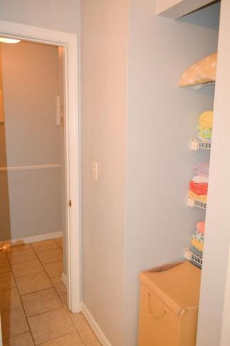 a room with a hallway with a closet with towels at Grand Caribbean 214W in Pensacola
