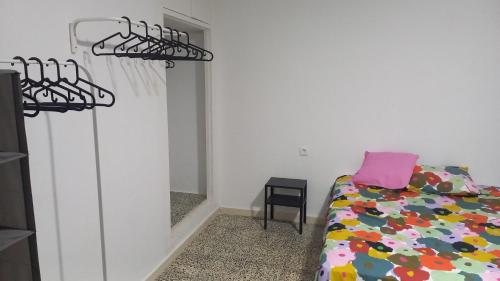 a bedroom with a bed and a mirror at Casa del Prendi in Jerez de la Frontera