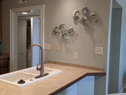 a kitchen with a sink and a mirror at Gulf Side Villa 1B in Pensacola
