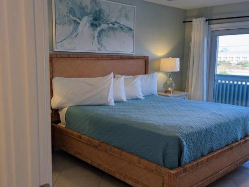a bedroom with a large bed with a window at Gulf Side Villa 1B in Pensacola