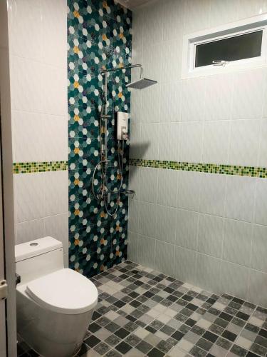 a bathroom with a toilet and a shower at Cherina Pool Villa 3 in Hat Yai