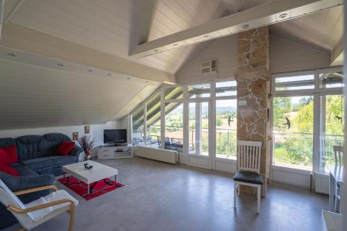 a living room with a couch and a table at Apartman Ivka in Rakovica