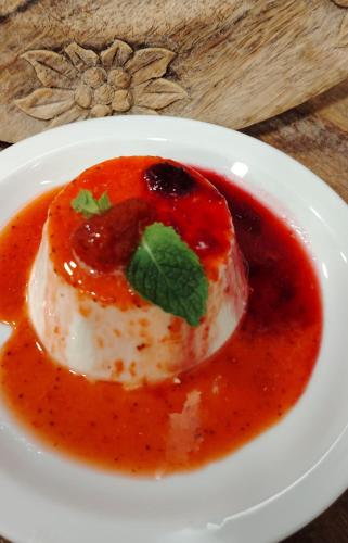 a white plate with a piece of food in sauce at Chalet BRAGARD in Limone Piemonte