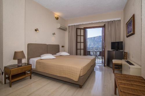 Postel nebo postele na pokoji v ubytování Olympic Hotel