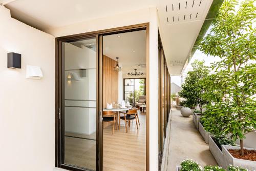 a glass extension to a house with a dining room at At Thaphae Hostel in Chiang Mai