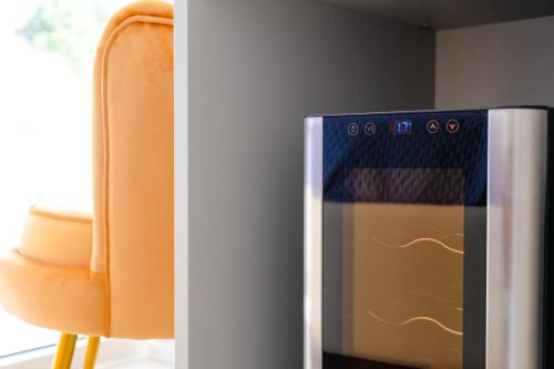 an orange chair sitting next to a refrigerator at Residence AleDen in Vieste