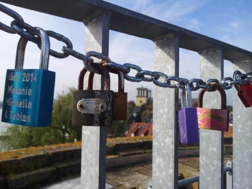 two locks on a chain attached to a bridge at Ferienwohnung "Erika" Rees am Niederrhein in Rees