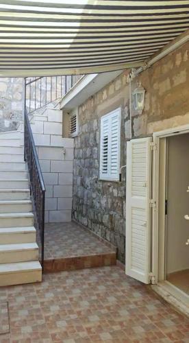 a building with a staircase and a door and a stair case at Emily Apartment in Suđurađ