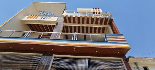 a building with balconies on the side of it at Awadh Royals Homestay Ayodhya in Ayodhya