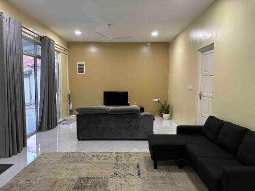 a living room with a couch and a table at Lavender Residence in Feydhoo