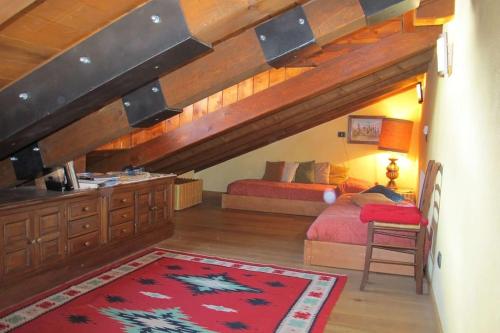 a bedroom with two beds and an attic at Villa Ada in Breuil-Cervinia