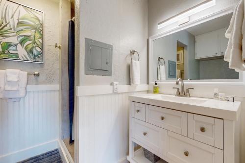 a white bathroom with a sink and a mirror at Prince Kuhio 323 in Koloa