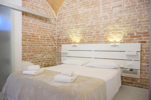 a bedroom with a white bed with towels on it at B&B Le Stanze di Ludovica in Termoli