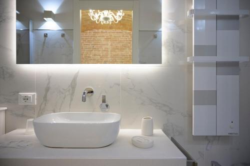 a white bathroom with a sink and a mirror at B&B Le Stanze di Ludovica in Termoli