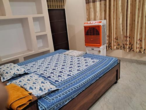 a bedroom with a bed and an air conditioner at Awadh Royals Homestay Ayodhya in Ayodhya