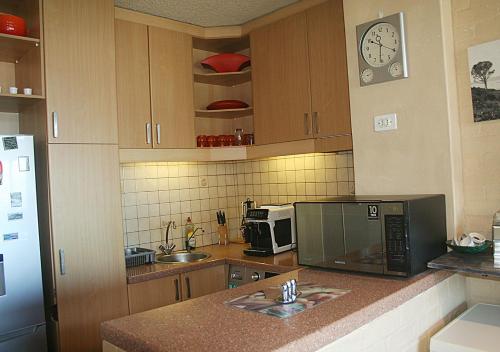 a kitchen with a microwave and a counter with a sink at U PRIVATE STUDIO apartment in Gardens Centre in Cape Town