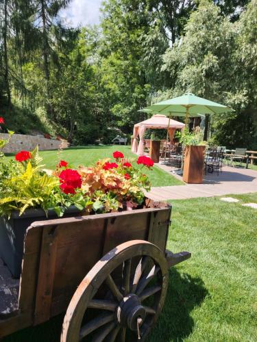 a wooden cart filled with flowers in a park at Chalet BRAGARD in Limone Piemonte