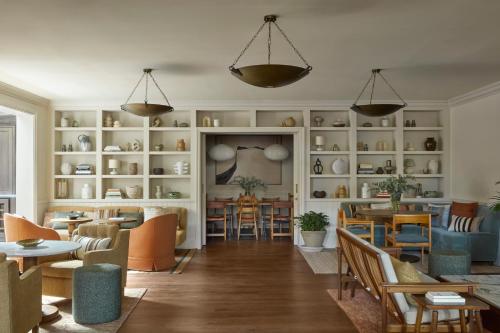 a living room with tables and chairs and shelves at Miiro Borneta in Barcelona